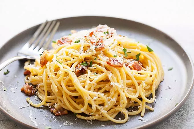 Spaghetti carbonara, ready to serve with a fork.