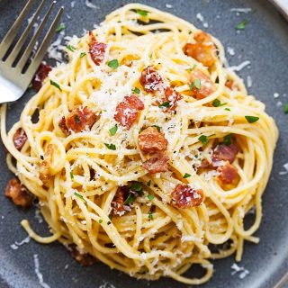 Spaghetti carbonara with a fork, ready to be served.