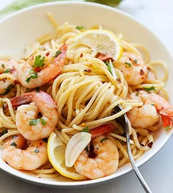 Shrimp scampi in a white serving plate, ready to serve.