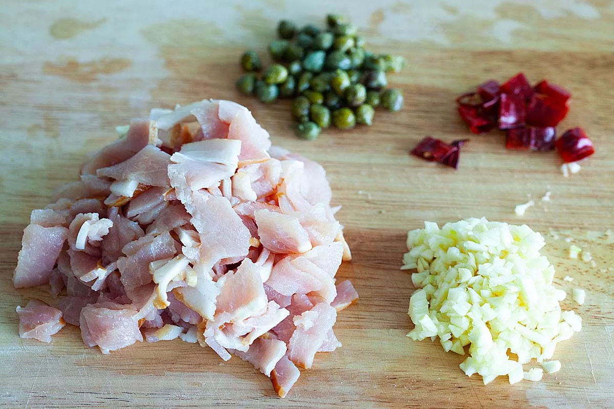 Bacon pasta ingredients are bacon, garlic, dried chili, and capers.
